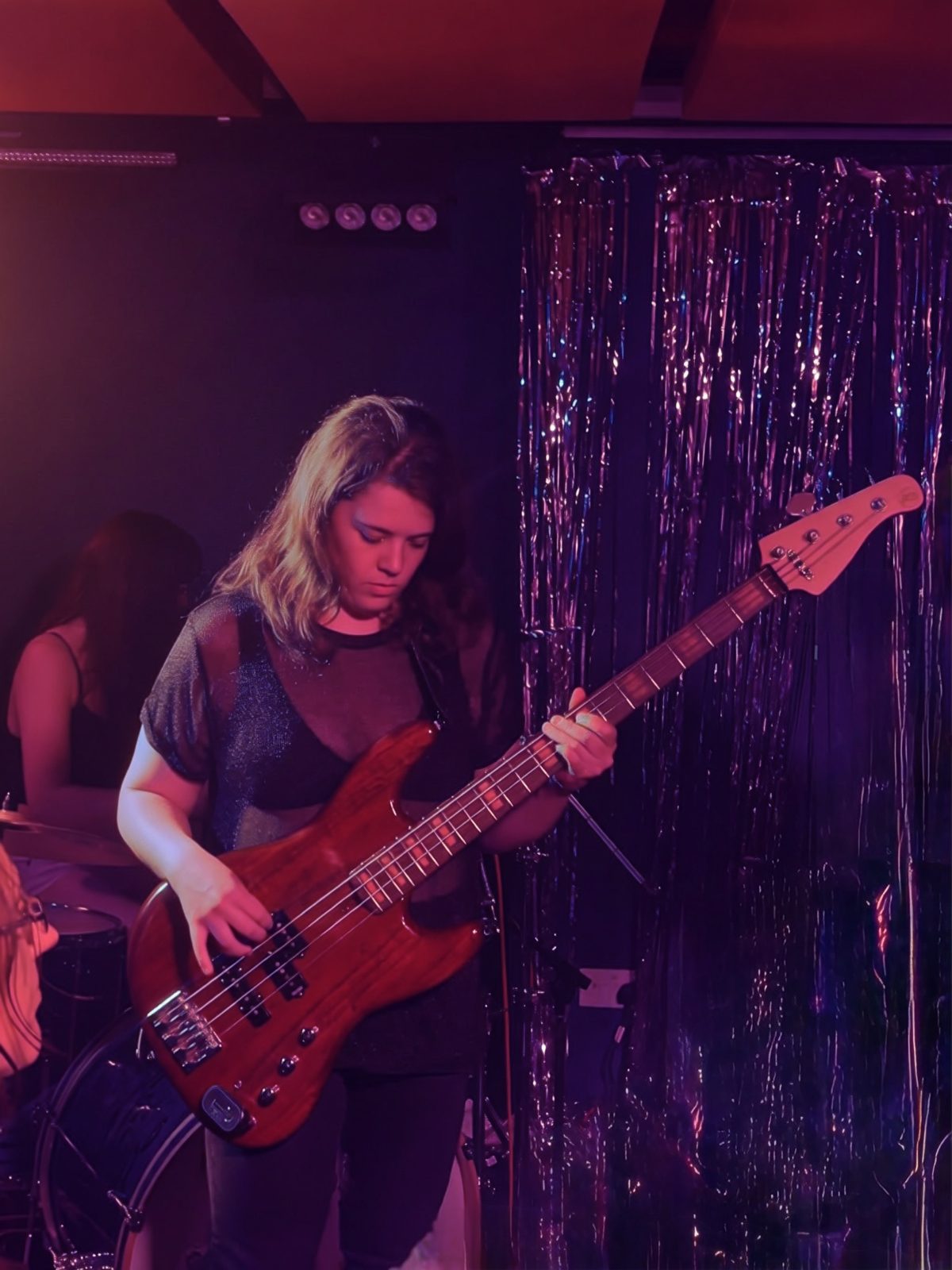 Saray playing bass live on stage